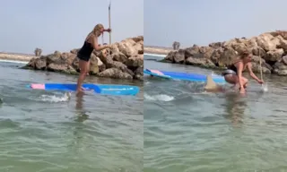 Imagem ilustrativa da imagem VÍDEO | Tubarão derruba mulher de prancha de stand-up paddle