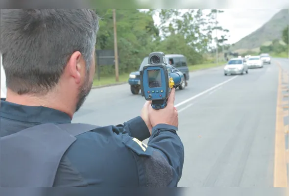 Policial rodoviário federal durante fiscalização em rodovia para aumentar a segurança e prevenir acidentes