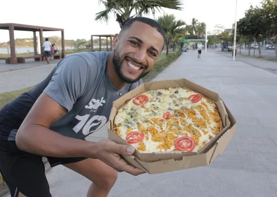 Imagem ilustrativa da imagem Influencer baiano distribui pizza  na orla da Camburi