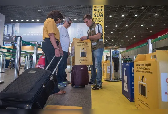 Funcionário mede malas em aeroporto: empresas aéreas têm liberado apenas item pessoal, ou seja, uma mochila