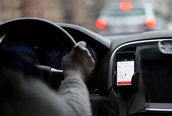 The Uber Technologies Inc. application runs on an Apple Inc. iPhone during an Uber ride in Washington, D.C., U.S., on Wednesday, April 8, 2015. Last month, Uber accounted for 47 percent of all rides expensed by employees whose companies use Certify, the second-largest provider of travel and expense management software in North America. In March 2014, Uber accounted for only 15 percent, according to a study by Certify released on April 7. Photographer: Andrew Harrer/Bloomberg via Getty Images