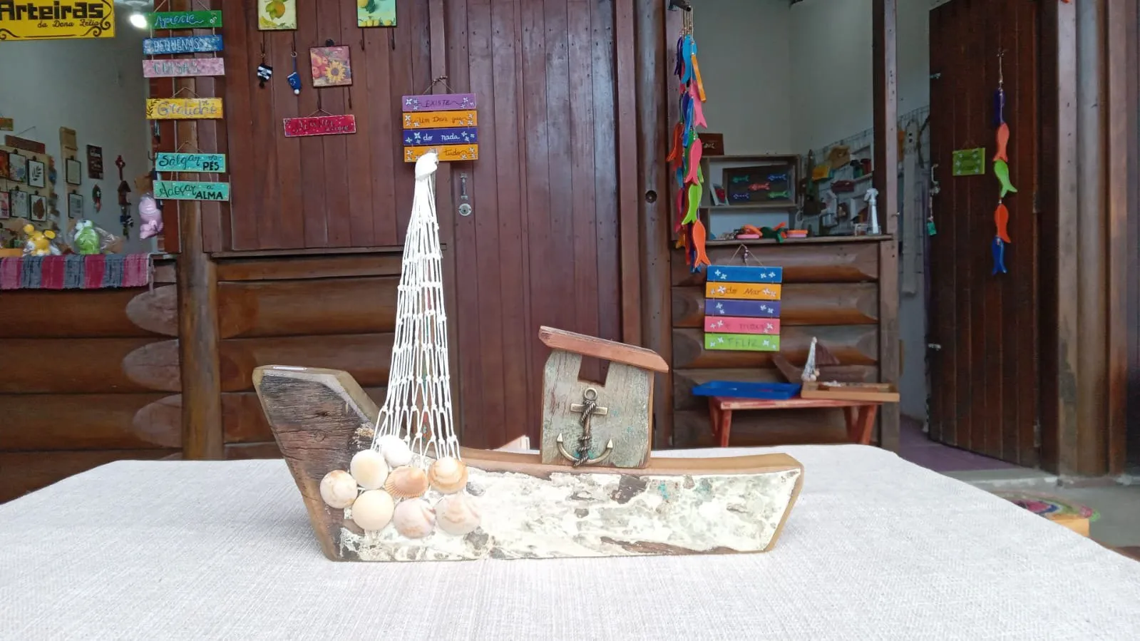 Escultura de madeira com concha e rede, em formato de barco, por R$ 55