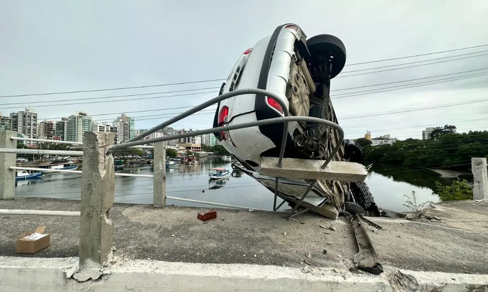 Imagem ilustrativa da imagem FOTOS | Carro de médica capota e fica pendurado em ponte de Vitória