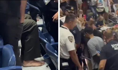 
          Imagem ilustrativa da imagem Manifestante cola pés na arquibancada e interrompe semifinal do US Open
          