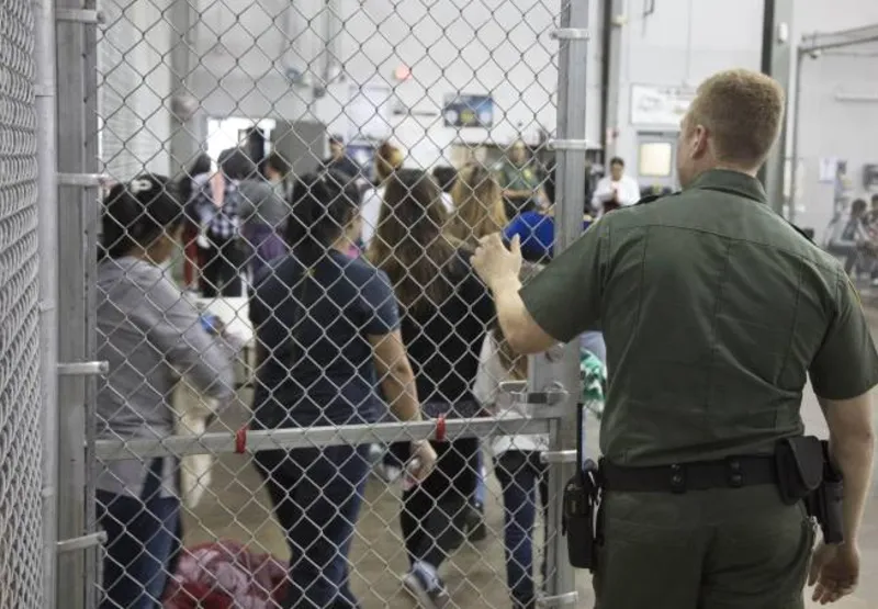 Agentes da Patrulha da Fronteira dos Estados Unidos conduzem a entrada de imigrantes ilegais no Departamento de Alfândega e Proteção de Fronteiras em McAllen, no Texas