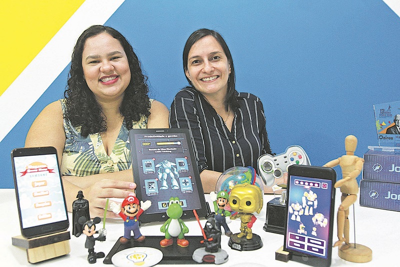 Elas deixaram a carreira para trabalhar com jogos, incluindo os digitais, e montaram a empresa Ludo Thinking. Na foto, elas mostram as telas com os jogos elaborados por elas (Foto: Foto: Kadidja Fernandes)