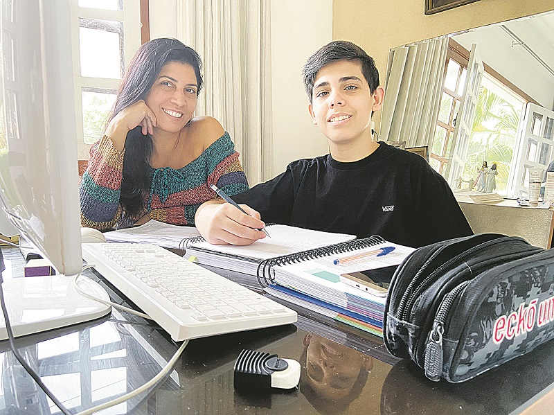 A operadora industrial Jussara Knaak ajuda o filho Leonardo Rezende, de 14 anos, nos estudos em casa (Foto: Acervo pessoal )