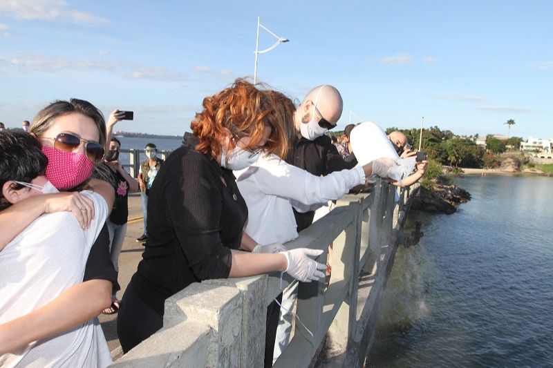 Amigos e familiares de aposentado vítima de Covid-19 jogam cinzas dele no mar de Vitória (Foto: Beto Morais/AT)