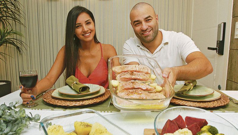 O casal Paulo Prezotti e Nathália Olli se reinventou e agora testa receitas mais elaboradas e saudáveis na cozinha, como o salmão com legumes. Eles pretendem manter o hábito de cozinhar em casa, mesmo após o fim da quarentena. “Estar à mesa em família é sagrado. É um momento de paz”, disse Nathália (Foto: Kadidja Fernandes / AT)