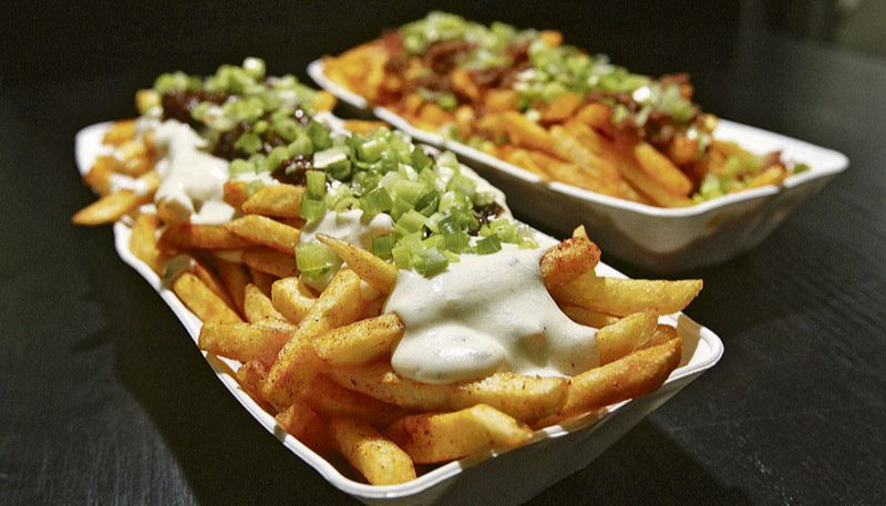Batatas fritas temperadas em duas versões: com molho quatro queijos e costela desfiada ao barbecue e com cheddar e farofa de bacon torrada (Foto: Beto Morais / AT)