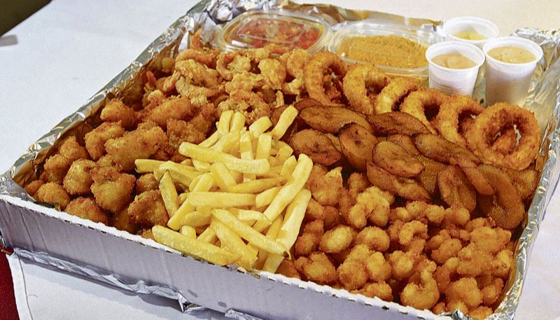 Box de petiscos, com camarões, lula à milanesa, batata frita, filezinho de peixe a palito, banana, vinagrete e molhos (Foto: Dayana Souza / AT)