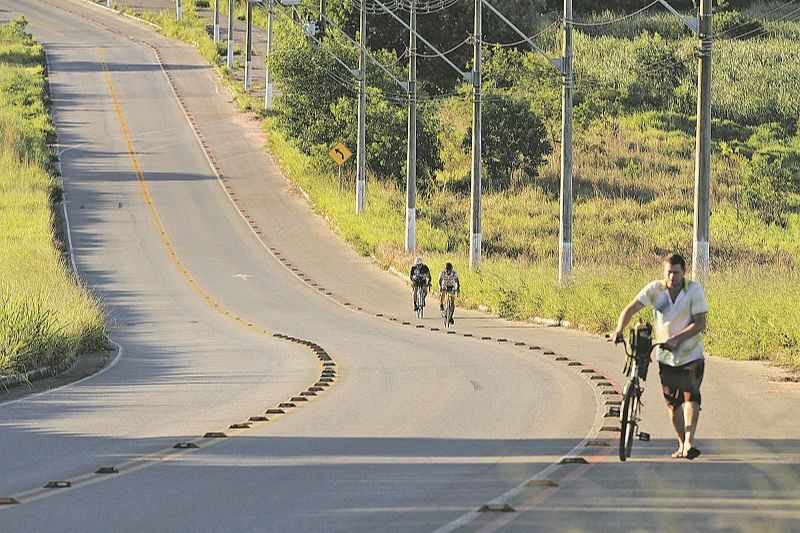 Moradores passam de bicicleta por trecho que, segundo ciclistas, precisa de segurança e grades de proteção (Foto: Beto Morais/AT)