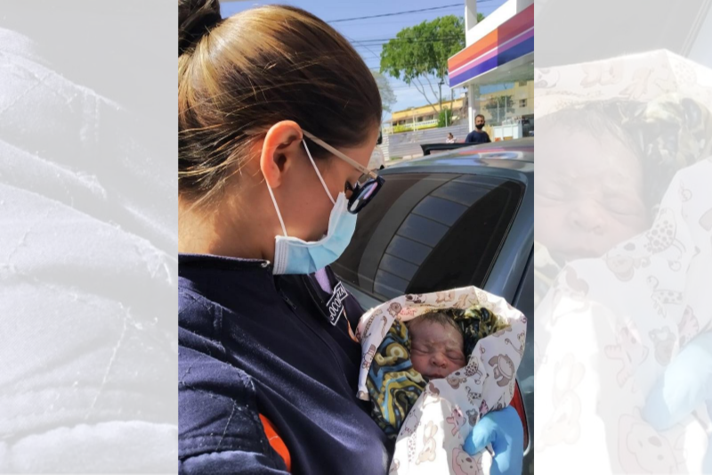 Socorrista com a pequena Emanuelle nos braços, ainda no posto de combustíveis (Foto: Divulgação)