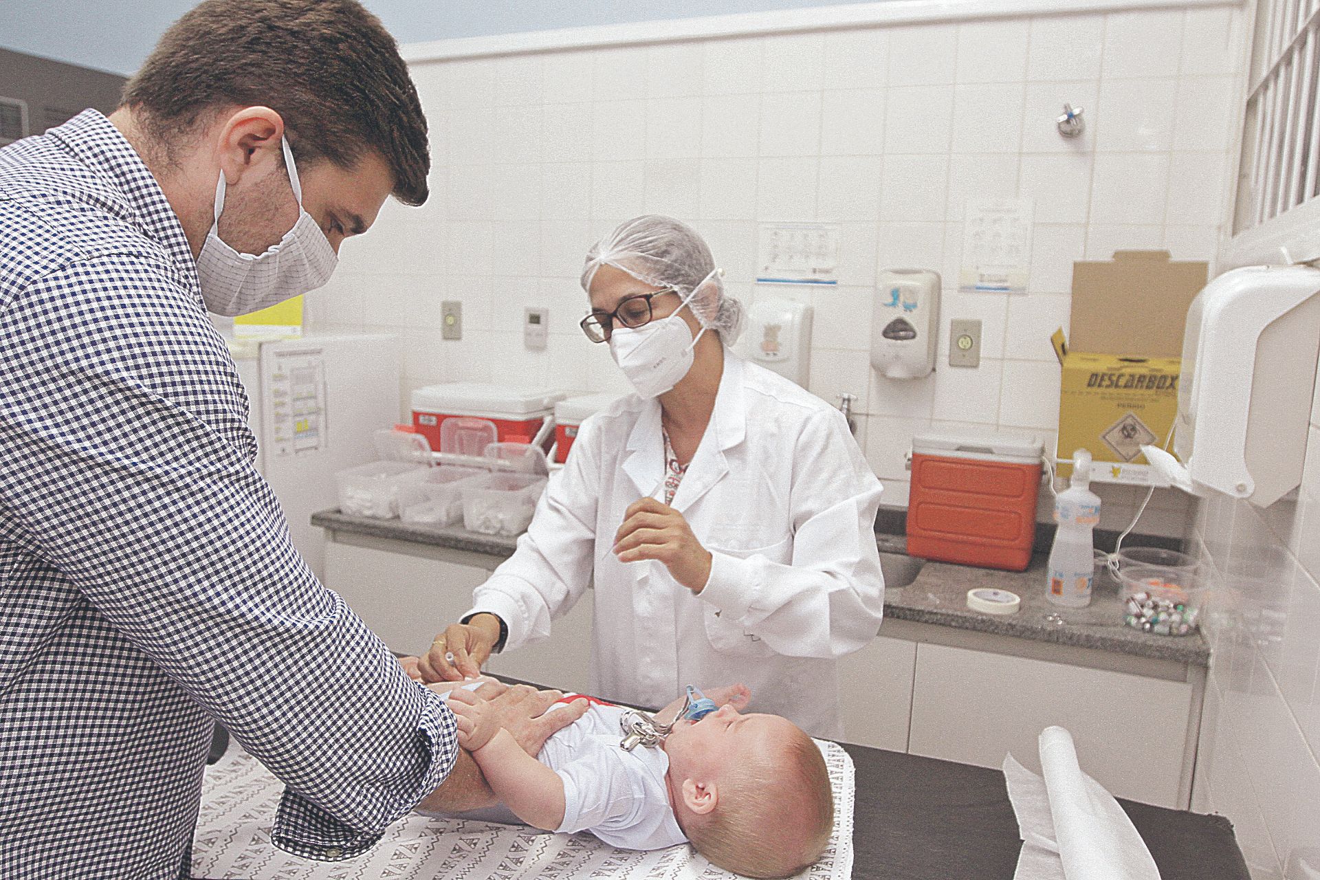 criança é levada pelo pai para receber vacina em posto de saúde de Vitória: cartão de vacinação deve ser mantido em dia, alertam os médicos e especialistas (Foto: Kadidja Fernandes/AT)