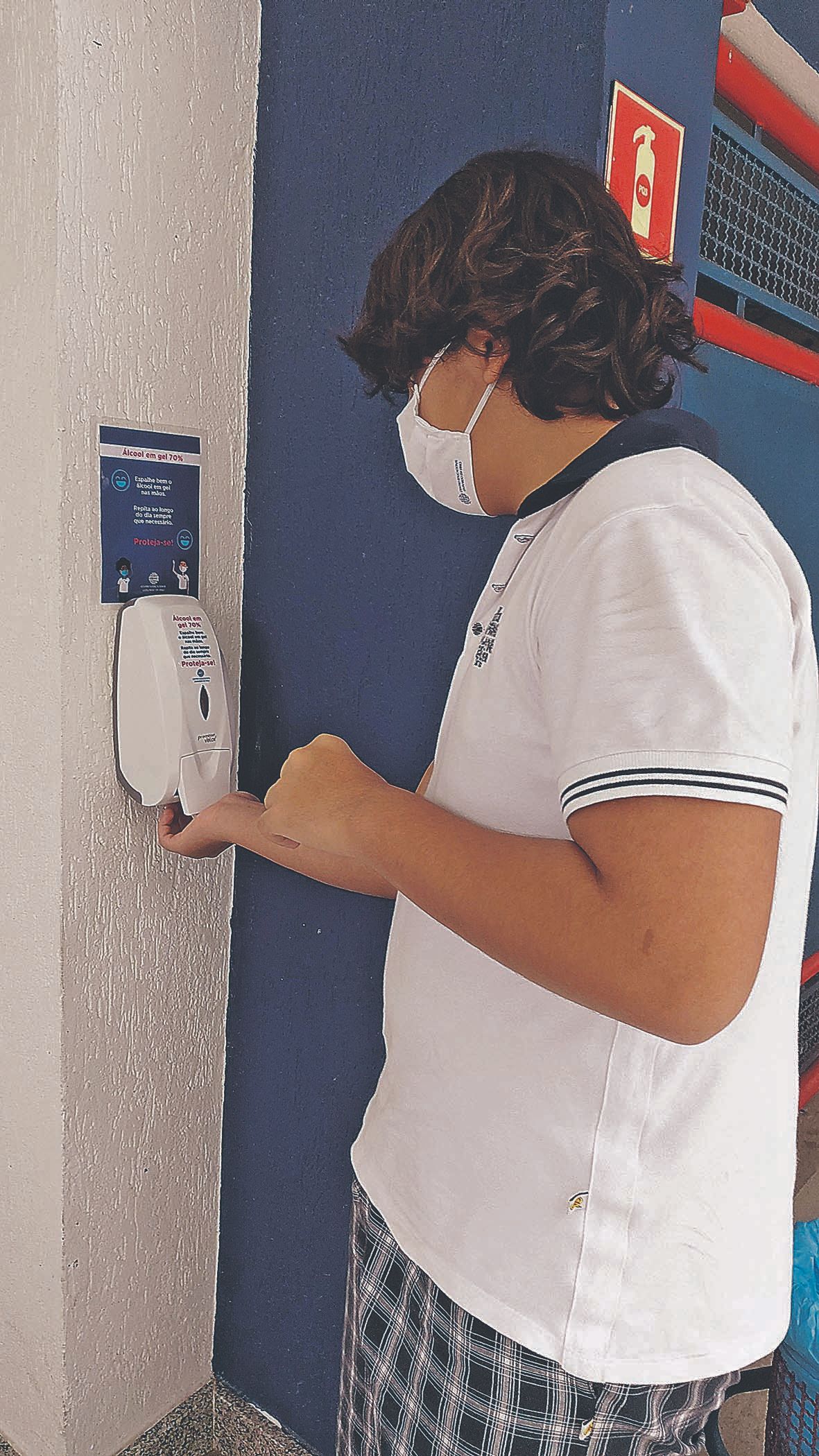 Estudante higieniza as mãos