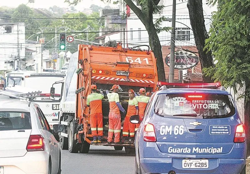 Escoltado por veículo da Guarda Municipal, caminhão circula por bairro de Vitória para fazer a coleta de lixo