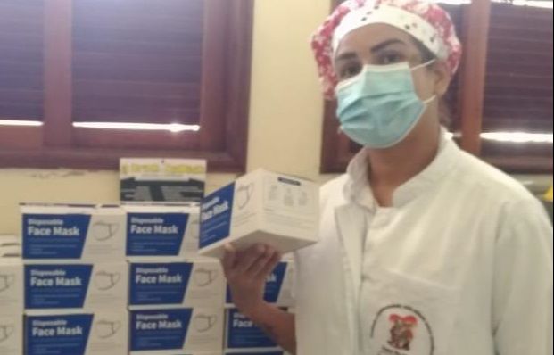 Funcionária da asilo de Ecoporanga com as caixas de máscaras recebidas do MPES. (Foto: Divulgação/MPES)