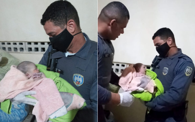 Os policiais segurando o bebê Micael (Foto: Divulgação)