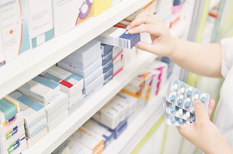Atendente procura medicamento em farmácia: pacientes com depressão também sofrem com falta de remédios (Foto: Arquivo/ AT)