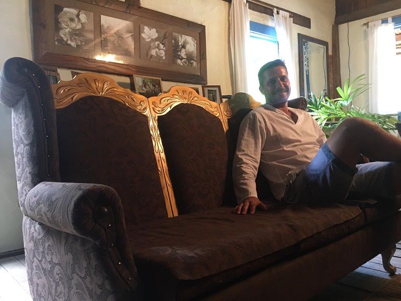 Giovani Módolo mostra sofá que, segundo o dono do casarão, pode ter pertencido à família imperial brasileira (Foto: Clóvis Rangel)