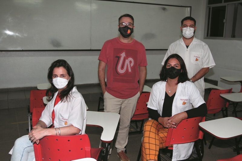 O diretor e professor Fábio Portela (de camisa vermelha) e sua equipe comemoram a vacinação dos profissionais da escola (Foto: Antonio Moreira/AT)
